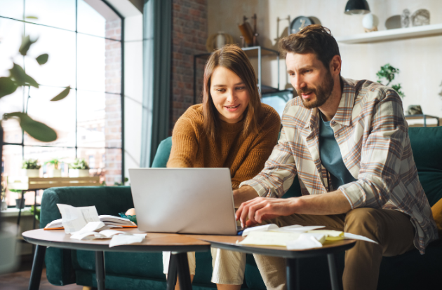 A couple reviewing tax information on a laptop.